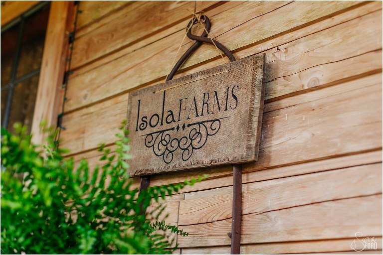 Wooden sign on main house at Isola Farms wedding 