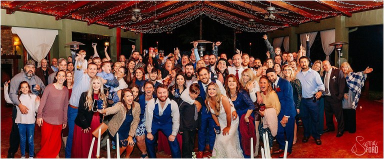 giant group photo of all guests who attended lakefront wedding