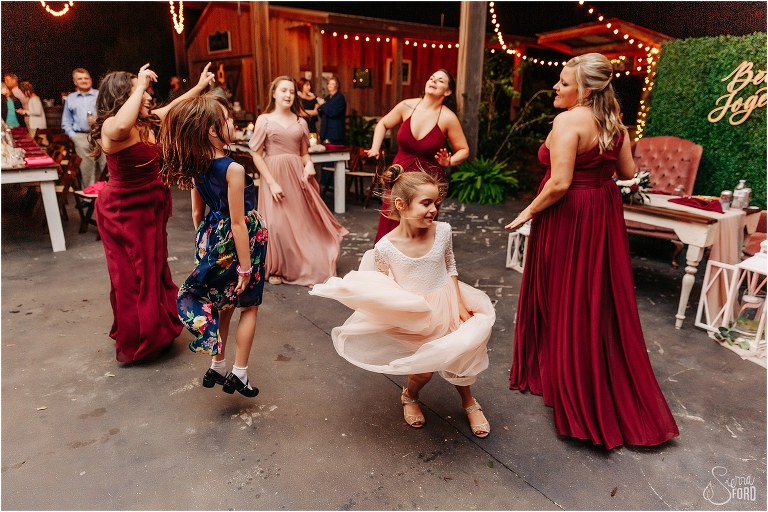bridesmaids and flower girls dance the night away at Isola Farms wedding