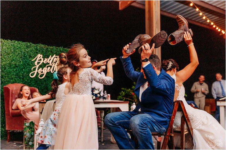 flower girl agrees with one of the answers of the shoe game at Isola Farms wedding