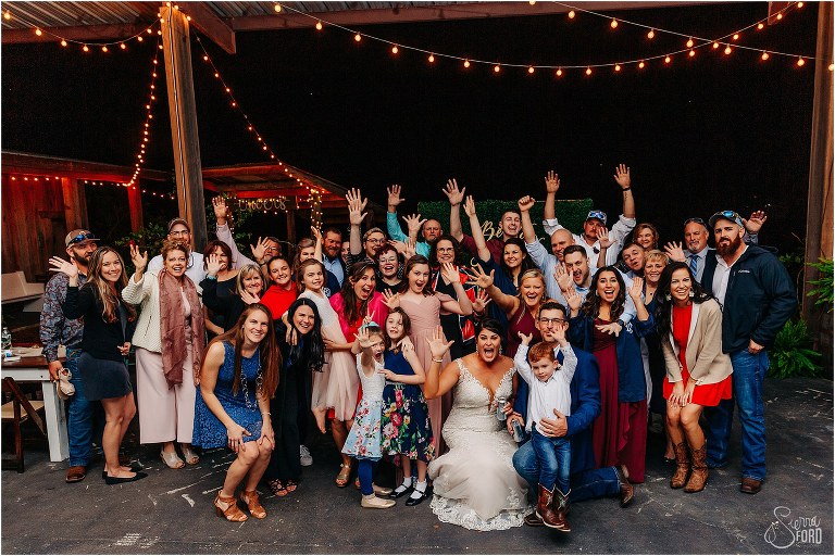 group photo of whole wedding at Isola Farms wedding reception
