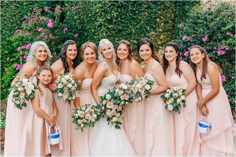 bride laughs with her bridesmaids in blush bridesmaid dresses at Bella Collina wedding