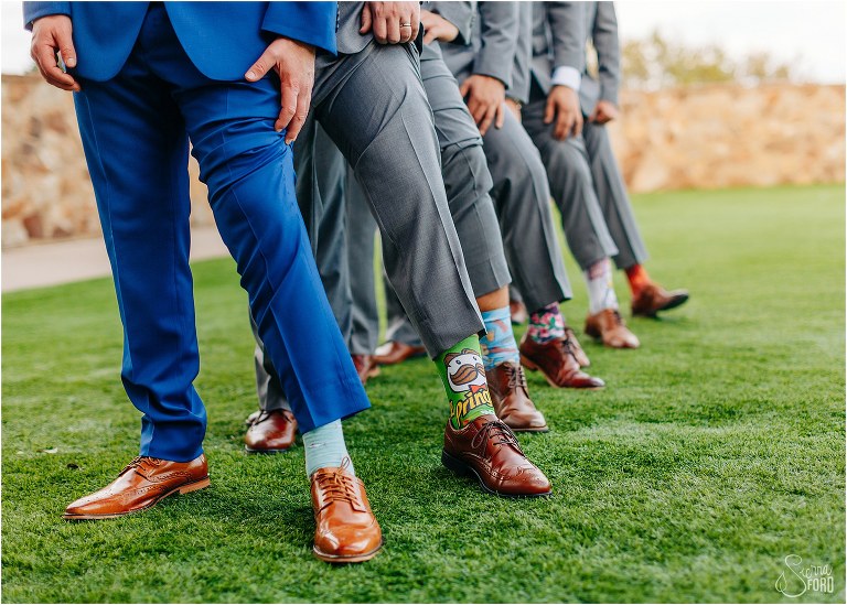 groom and groomsmen show off their funny socks at Bella Collina wedding