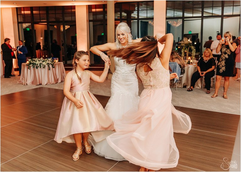 bride twirls flower girls at Bella Collina wedding reception