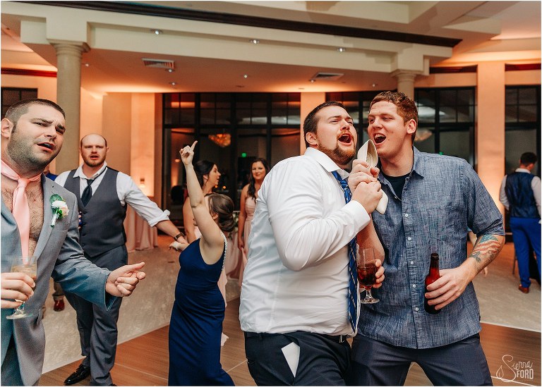 guests use heel as microphone on dance floor at Bella Collina wedding