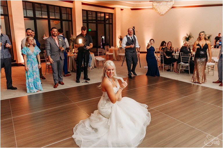 bride drops to the floor to lip sync lyrics on the dance floor at Bella Collina wedding