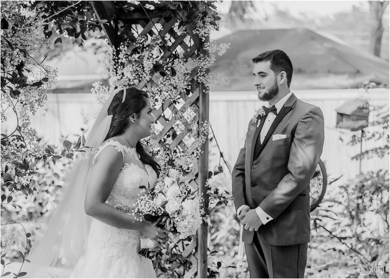 groom looks lovingly at bride as she arrives at the alter for their Mount Dora tiny wedding