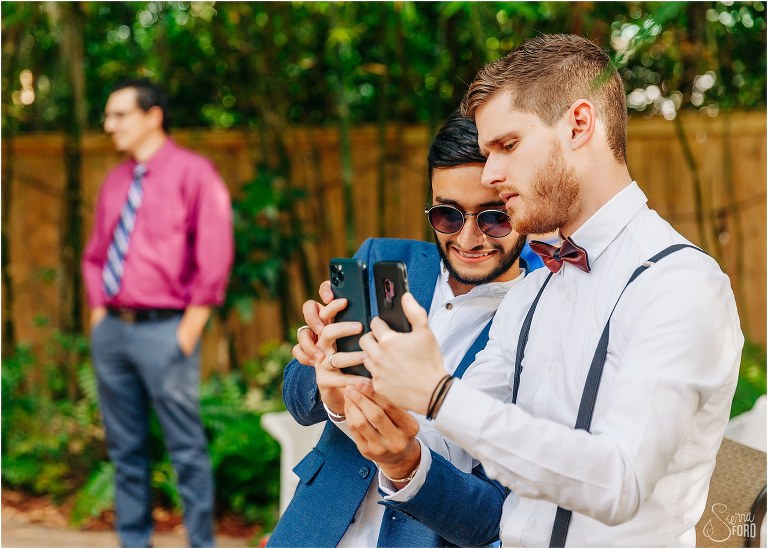 friends hold up phones so out of town guests can Facetime to watch the Mount Dora tiny wedding