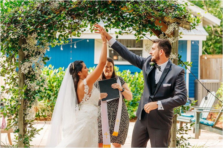 bride and groom REALLY seal the deal with a "just married" high five at Mount Dora tiny wedding ceremony
