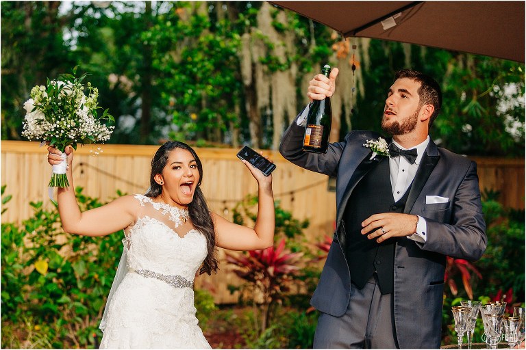 bride and groom throw up hands in celebration after Mount Dora tiny wedding ceremony