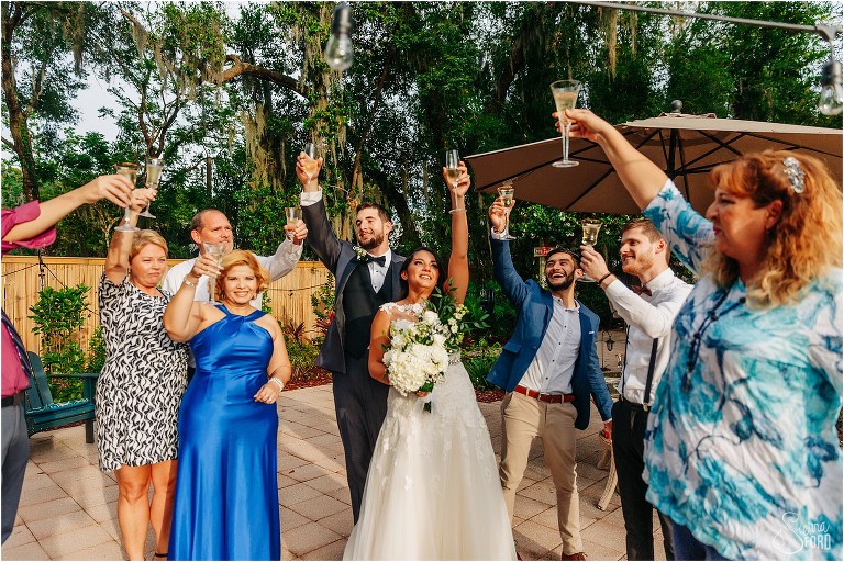 guests at Mount Dora tiny wedding raise glasses in celebration of bride and groom