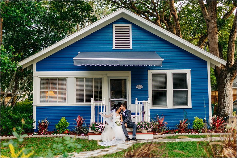 groom kisses bride's forehead as they snuggle up on cottage porch at Mount Dora tiny wedding