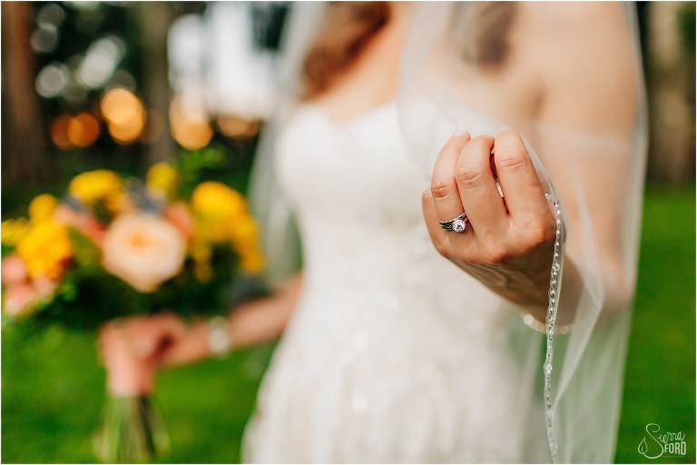 closeup of bride's added wedding ring as she adjusts her veil at Kraft Azalea park wedding