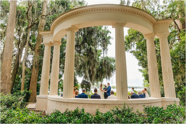 bride & groom say "I do" surrounded by giant columns and oak trees at Kraft Azalea park wedding