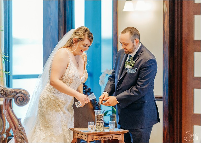 bride and groom pour hops and malt into unity jar for their home at Tavares Pavilion wedding ceremony