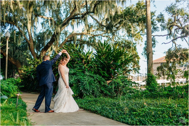 groom spins new bride among the greenery at Tavares Pavilion wedding