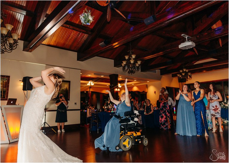 all the single ladies raise arms to catch bouquet as bride releases it at Tavares Pavilion wedding