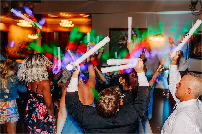 custom rainbow glow sticks light up the dance floor at Tavares Pavilion wedding