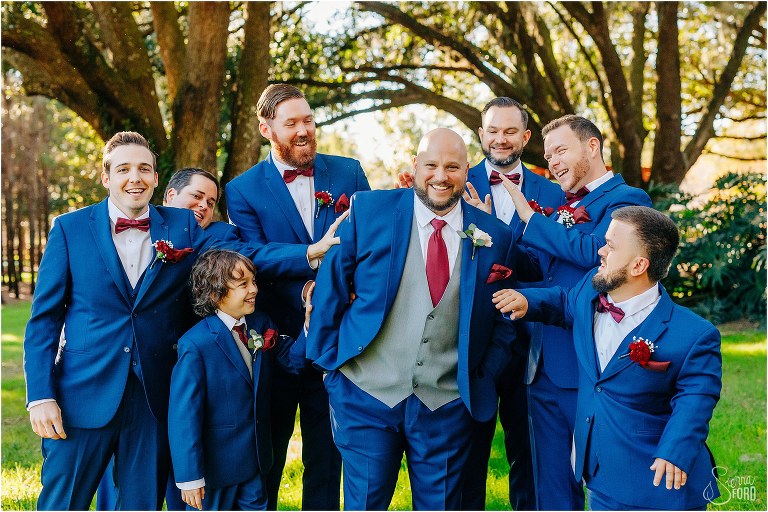 groomsmen laugh as they give groom a hard time at rustic Apopka wedding