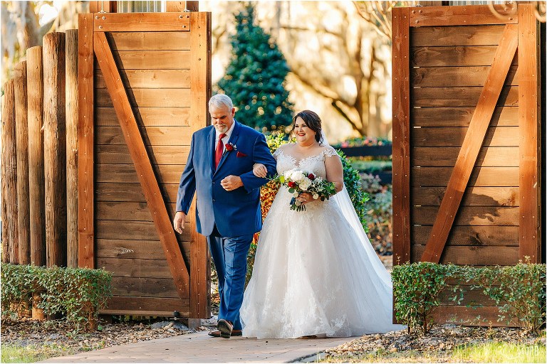 bride and her father come through barn doors at rustic Apopka wedding