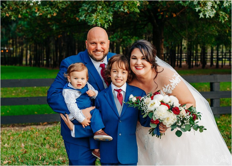 bride and groom smile with their two sons as their new family