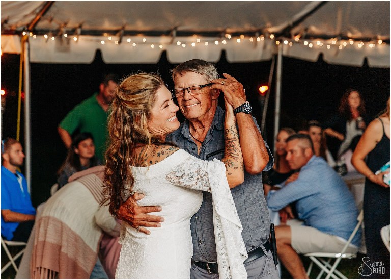 bride laughs as she shares dance with father at St. Pete backyard wedding reception