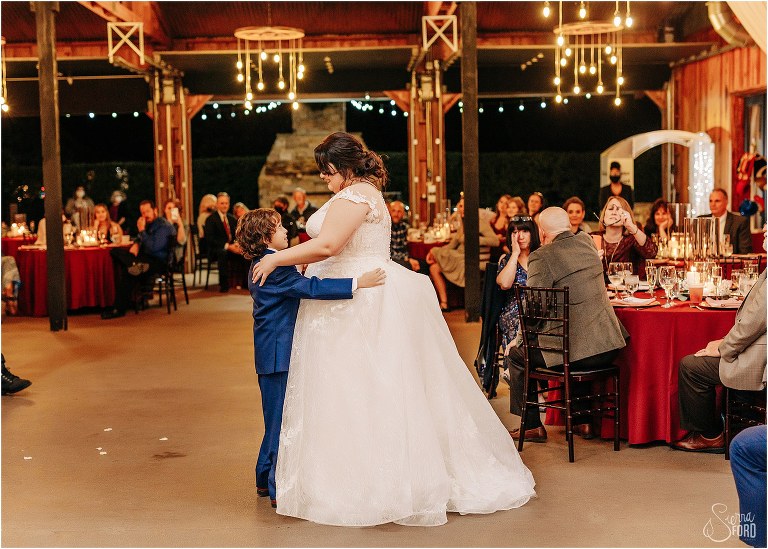bride shares dance with son as guests look on at rustic Apopka wedding