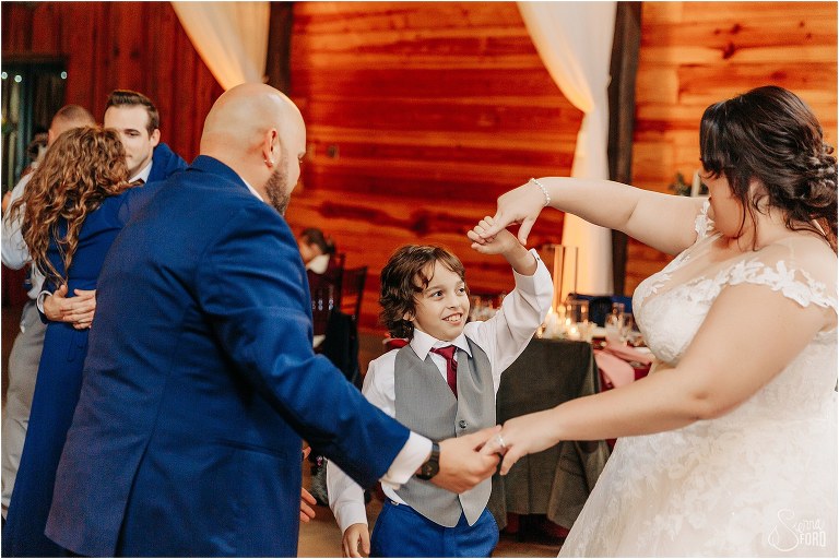 bride and groom share dance with older son
