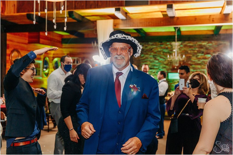 father of the bride dressed up in goofy hat and glasses 