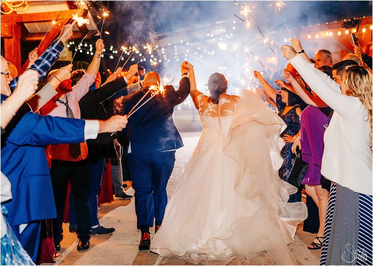 couple runs back through sparkler tunnel at rustic Apopka wedding