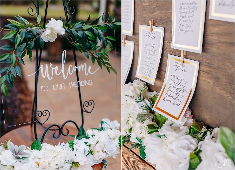 left, clear glass welcome sign with white & green florals, right, wooden seating chart at Hidden Barn wedding