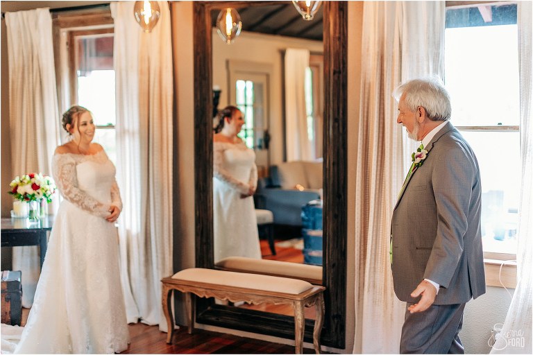 bride beams as father sees her for first time before The Acre Orlando wedding