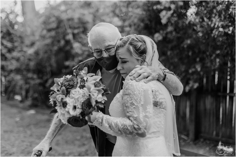 bride shares emotional hug with elderly wedding guest before The Acre Orlando wedding