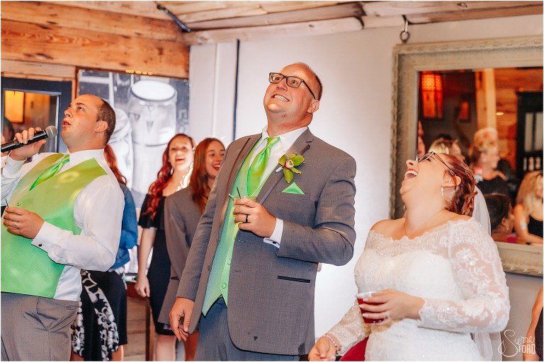 bride and groom laugh as they share silly dance at The Acre Orlando wedding