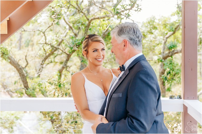 father of the bride smiles from ear to ear seeing his daughter for first time at Bayfront Lodge wedding