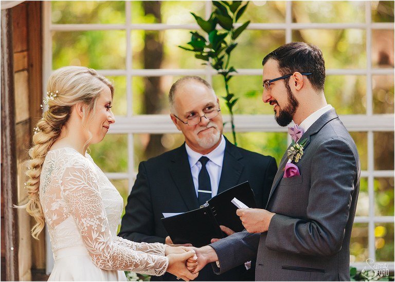 groom looks lovingly at bride during emotional vows at Bridle Oaks wedding