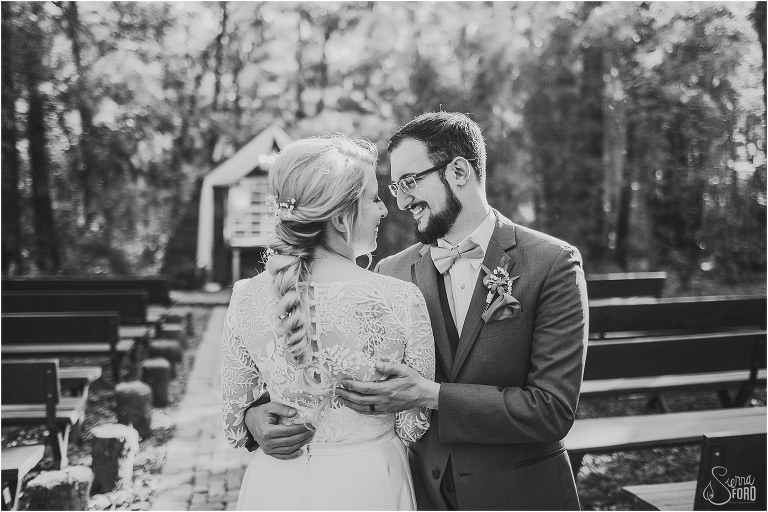 groom holds bride as he stares lovingly at her at Bridle Oaks wedding