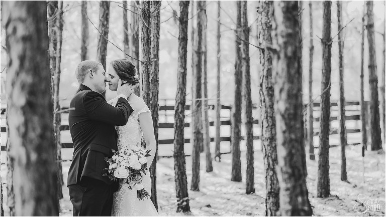 groom leans in for a kiss among the pine trees at rustic Apopka wedding