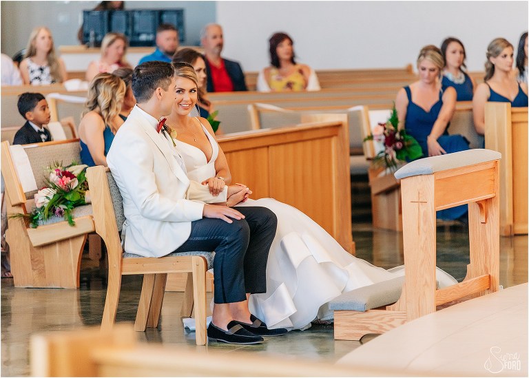 bride & groom steal a glance at each other during prayer at Bayfront Lodge wedding