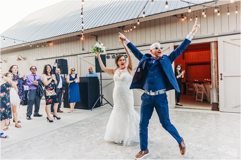 groom leaps into air as he enters reception with new bride at October Oaks wedding